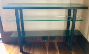 Several glass and dark metal side tables